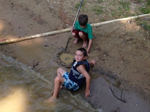 boys digging at the lake