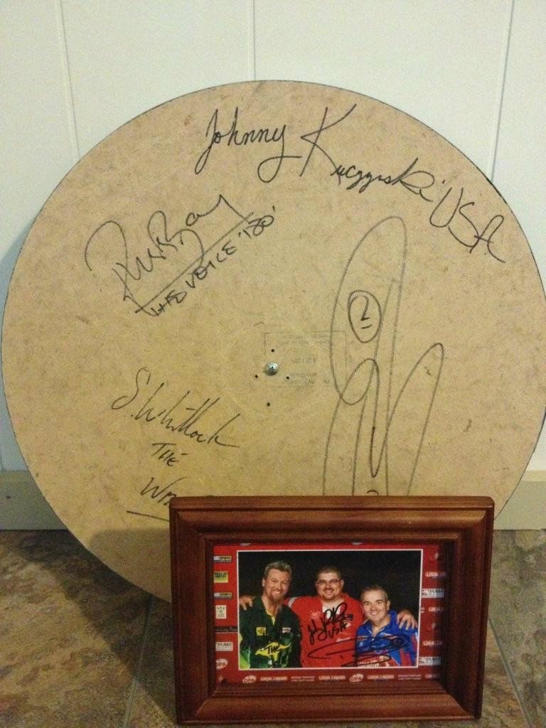 Phil Taylor, Simon Whitlock, Russ Bray and Johnny K signed dart board